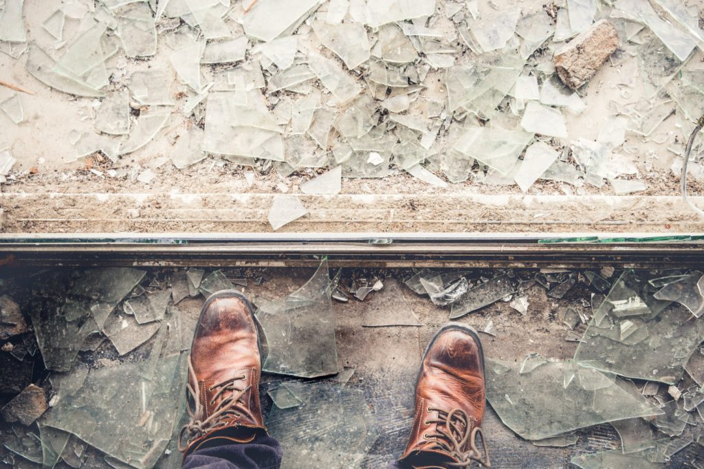 A person standing on glass shards.