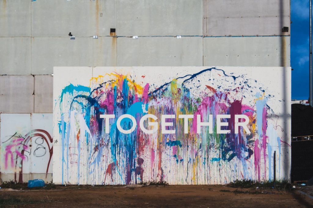 A word "together" on a colorful mural.