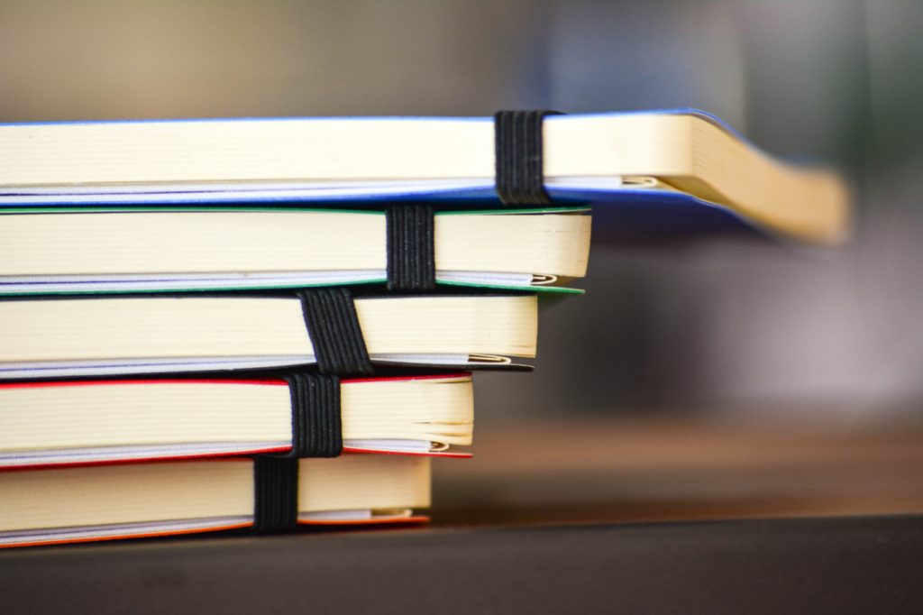 A stack of books on a desk.