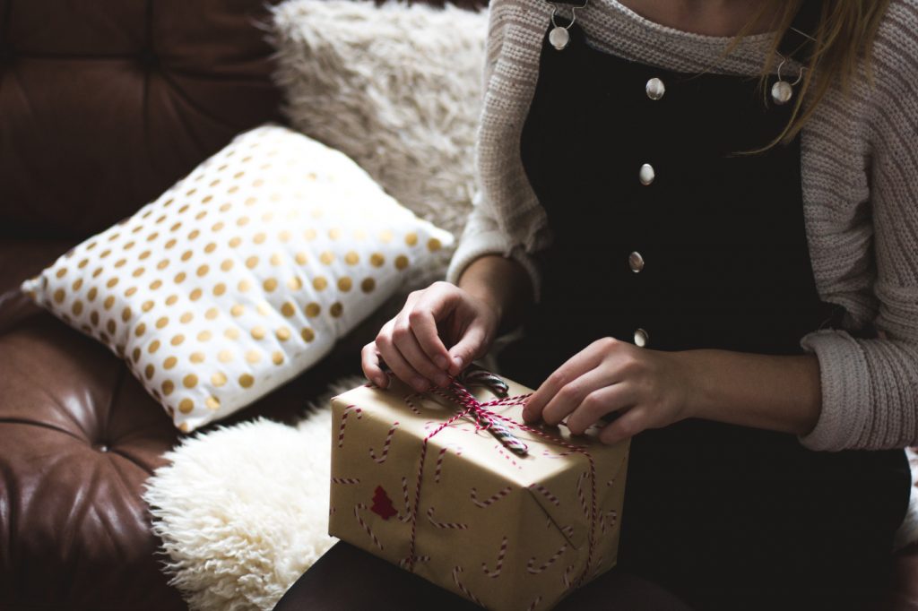 A woman opening a gift box.