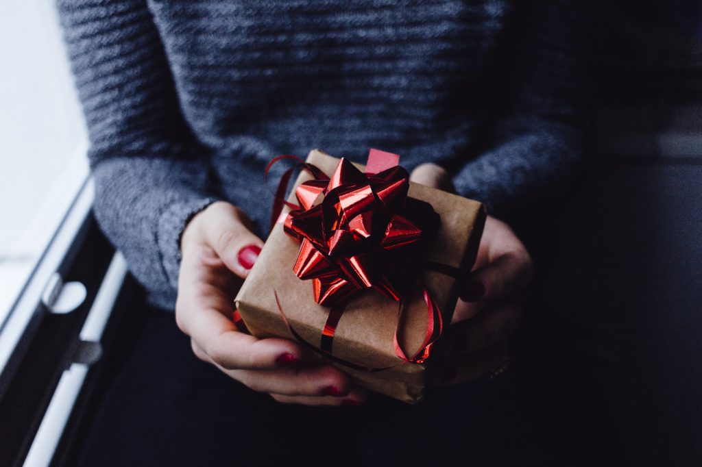 A person holding a nicely wrapped gift.