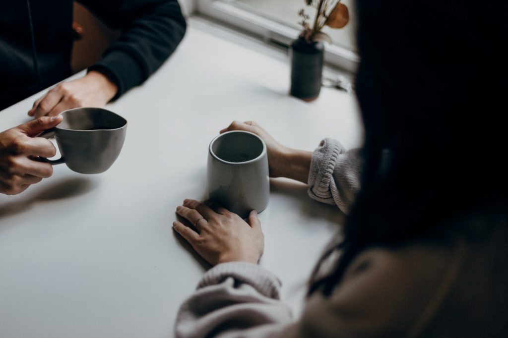 Two people in a discussion at a table.