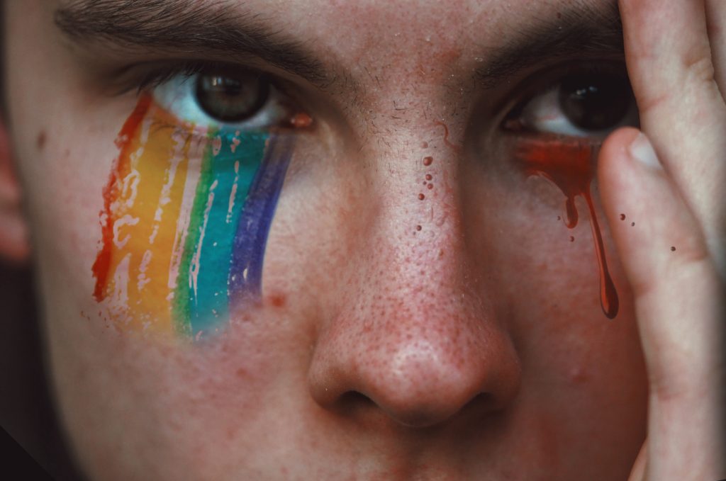 A person with rainbow eyeshadow that looks like tears.