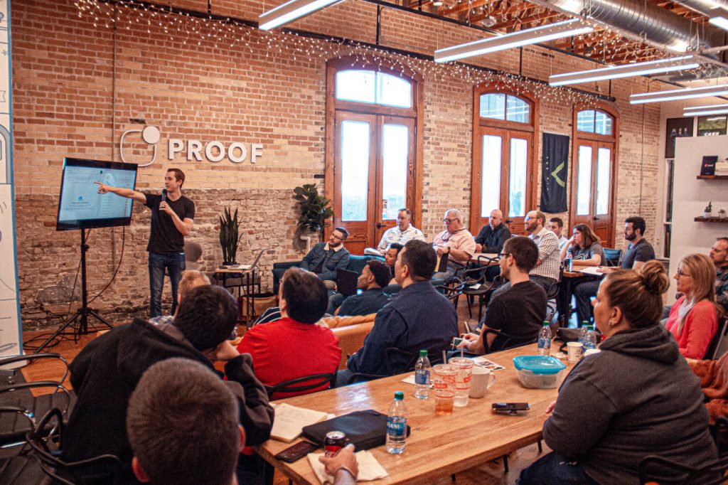 A person giving a talk to a small audience.