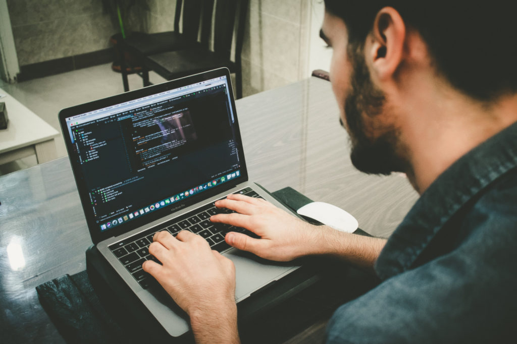 A person programming on a laptop.