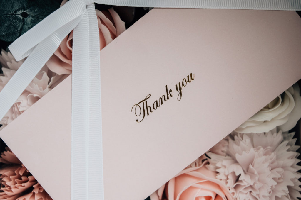 A white card with the text "thank you" on it.