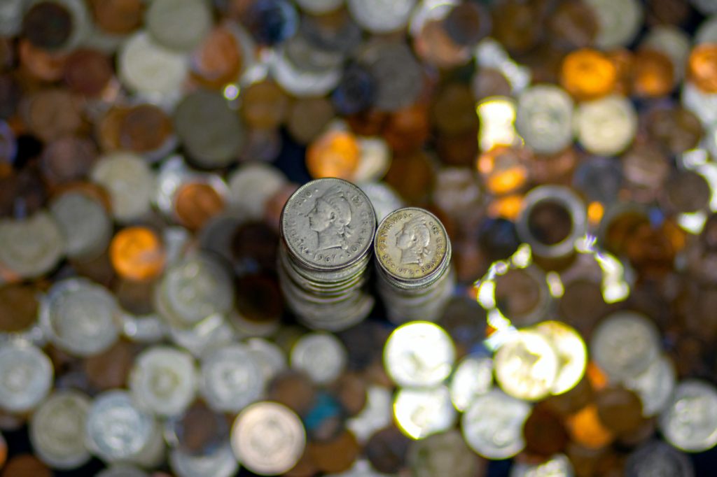 A stack of silver coins on a desk.