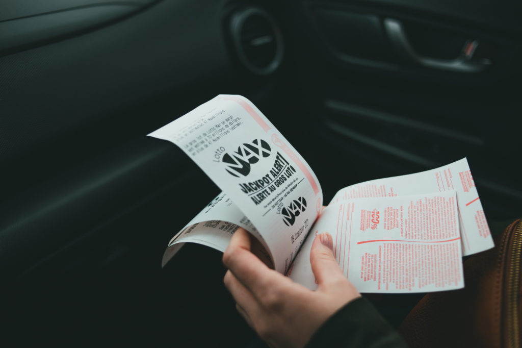 A person holding lottery tickets.