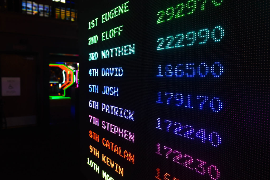 A digital scoring board with top ten results.