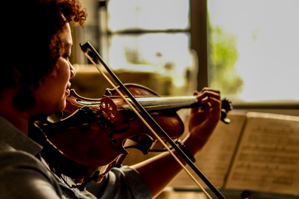 A woman playing the violin.