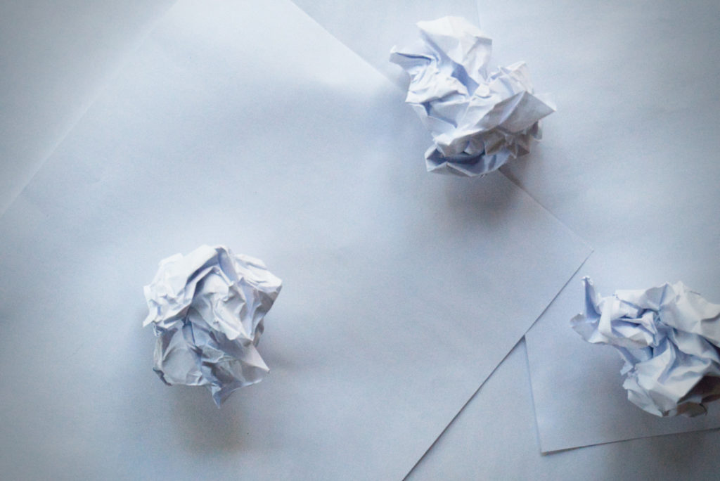 Crumpled papers on a desk.