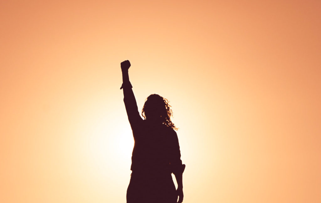 A person rising their fist to the sky.
